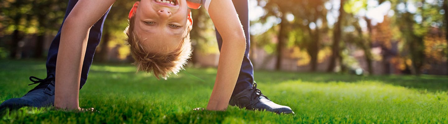 boy playing in the grass