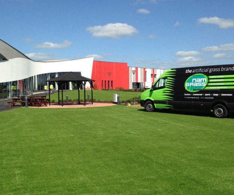 artificial grass laid outside large car show room