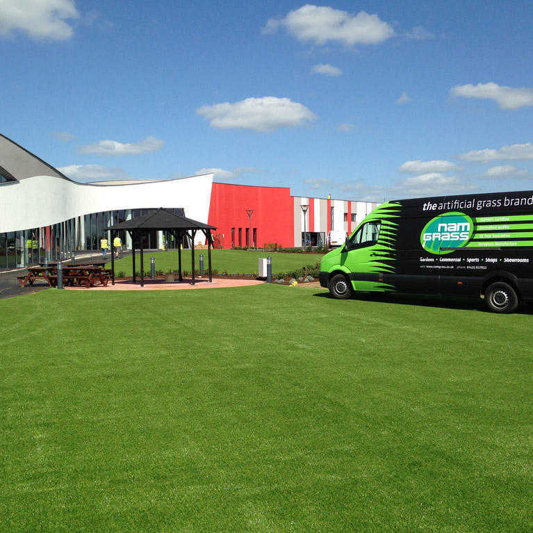 artificial grass laid outside large car show room