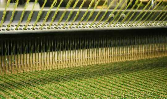 machine creating fake grass yarn