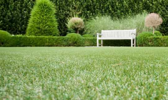 white bench on artificial grass