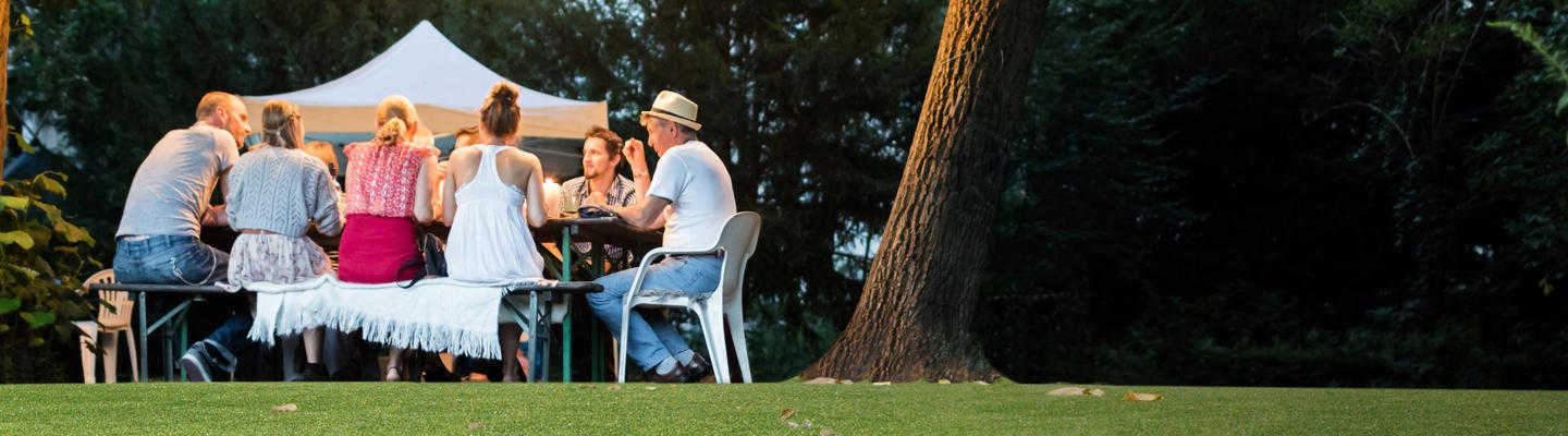 family dine round table on artificial grass