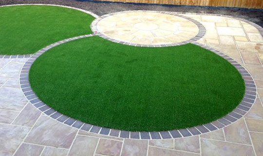 Artificial grass within patio stone circles